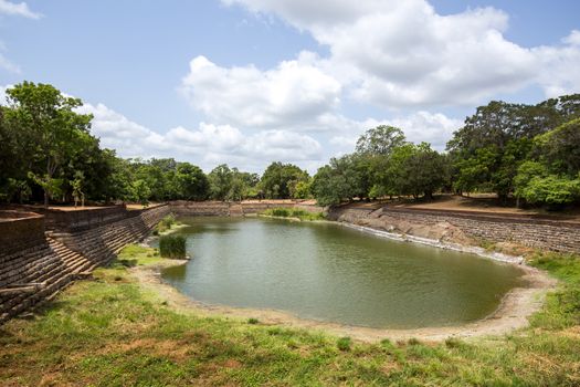 Anuradhapura, Sri Lanka - August 21, 2018: The Elephant Pond, Eth Pokuna in the ancient city. It's the largest man-made pond at the UNESCO site of Anuradhapura.