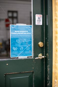 Copenhagen, Denmark - March 17, 2020: Sign on a restaurant door informing about the coronavirus.