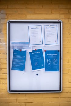 Copenhagen, Denmark - March 17, 2020: Information board about the corona virus on a public playground.