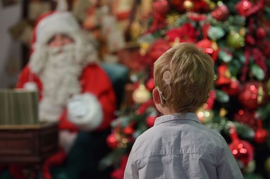 A Boy with Cochlear Implants and Santa Claus in Studio