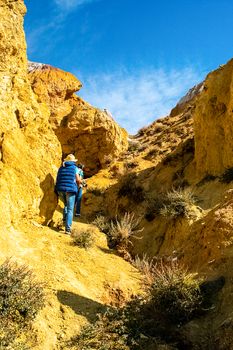 People walk among the rocks through the gorge.