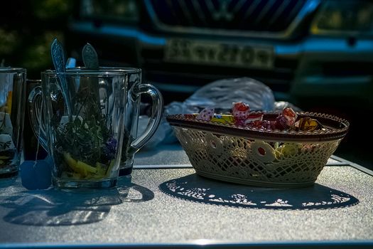 Glasses with tea leaves and a vase of sweets on the table. Tea drinking.