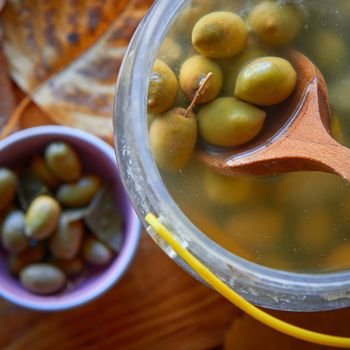 A jar with some exquisite spiced green olives