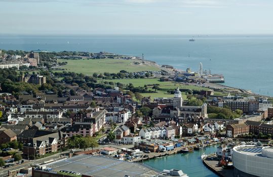 Aerial view across Portsmouth with the historic cathedral, and beyond to Southsea Common with the funfair and beach.