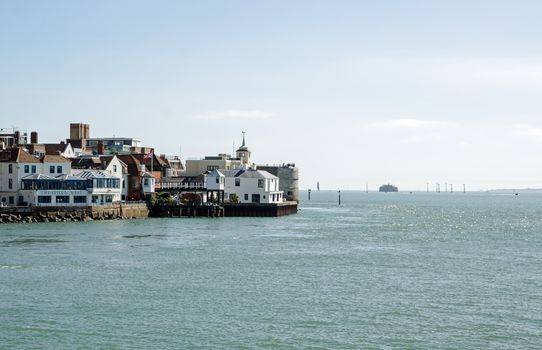 Portsmouth, UK - September 8, 2020: View across Portsmouth Harbour towards the historic Portsmouth Point area of pubs and fortifications seen on a sunny day in Hampshire.