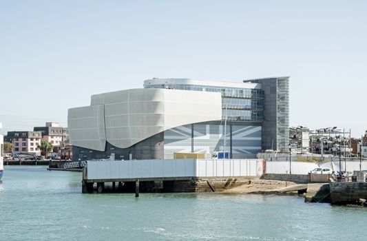 The landmark headquarters of the sailing organisation Ben Ainslie Racing overlooking Portsmouth Harbour on a sunny summer day.  Sir Ben Ainslie is on of the UK's most successful sailors, winning gold Olympic medals in several games.