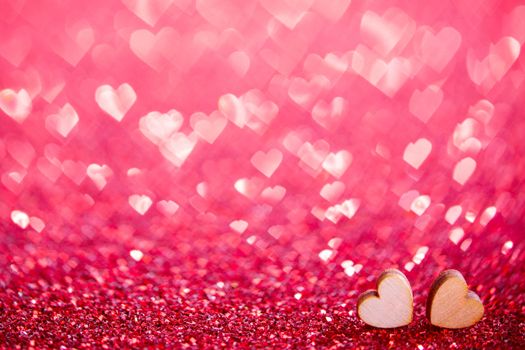 Two small wooden hearts symbol of love on background with beautiful bokeh, Saint Valentine Day celebration, copy space for text