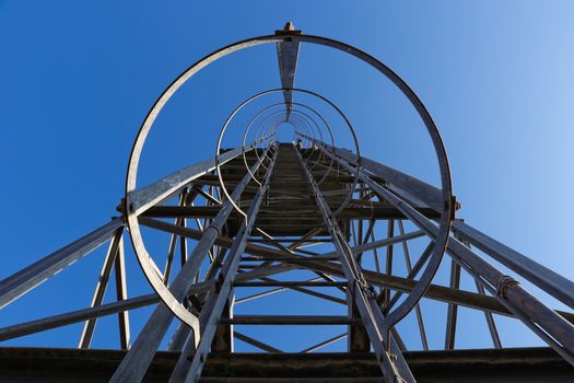 Low angle perspective view of a galvanized steel frame water tower ladder, Burgersfort, South Africa