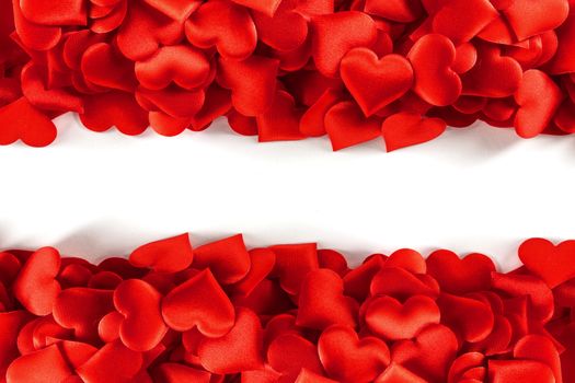Valentine's day many red silk hearts background , border frame isolated on white with copy space, love concept