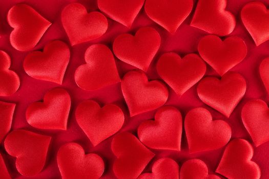 Valentine's day many red silk hearts background, love concept