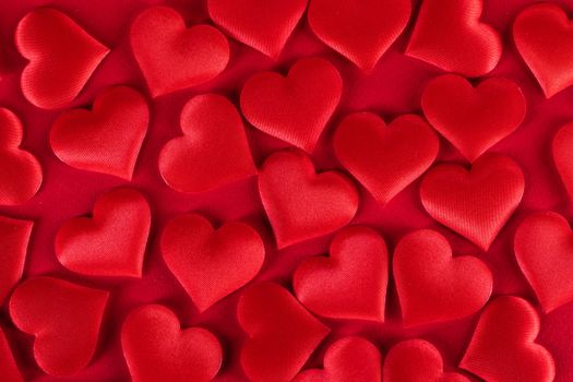 Valentine's day many red silk hearts background, love concept