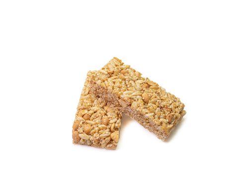 The close up of homemade Thai sweet cereal bar candy on white background, traditional muesli food in thailand.