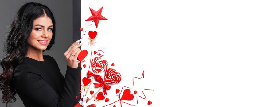 Happy woman holding magic wand and posing with Valentine's day decoration with white copy space background