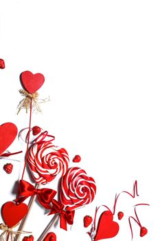 Valentines day decoration and heart shaped lollipops isolated on white background