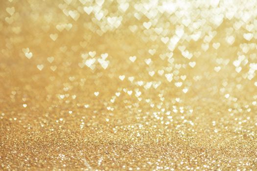 Golden glitter heart shape bokeh abstract background for Valentine day