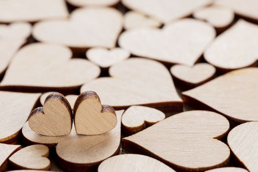 Many wooden colorless hearts background, two special ones true love concept