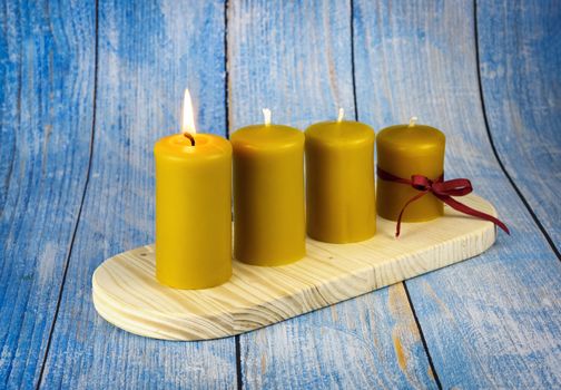 seasonal background four yellow candles on an advent candle