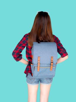 Back view of beautiful young asian woman travel with backpack isolated on blue background, rear asia girl is student or tourist in vacation in summer trip, holiday and traveller concept.