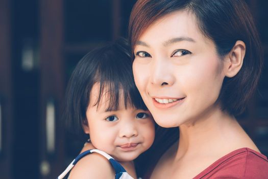 Family with portrait relationship of young asian mother and daughter cheerful and happy, mom and child smiling and hugging, expression emotion together, parent care kid, lifestyle concept.
