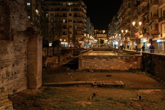 lluminated night view of festive instalments at the city center, around Roman ruins.