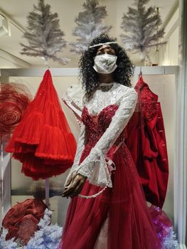 Closed due to covid-19 measures store with display dummy wearing face mask, dressed as a bride.
