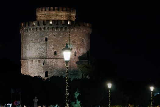 The city's landmark with illuminated seasonal instalments under dark sky.