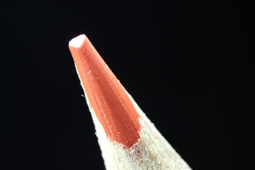 close up of sharpened pencil. Macro view of the tip of the pencil on a black background.