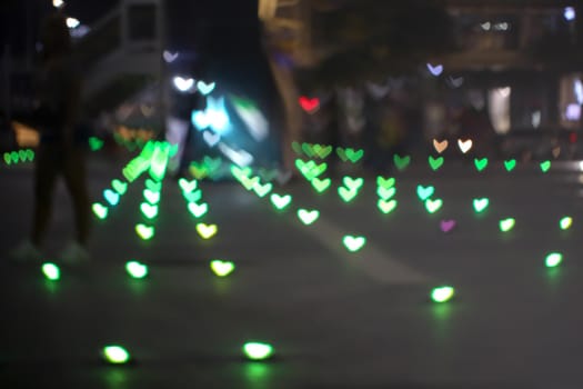 green bokeh and blur heart shape love valentine colorful night light on floor