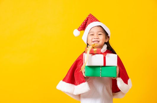 Kid dressed in red Santa Claus hat hold gift box on hands