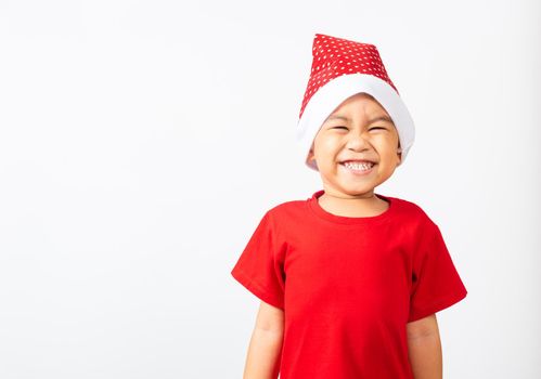 Kid dressed in red Santa Claus hat