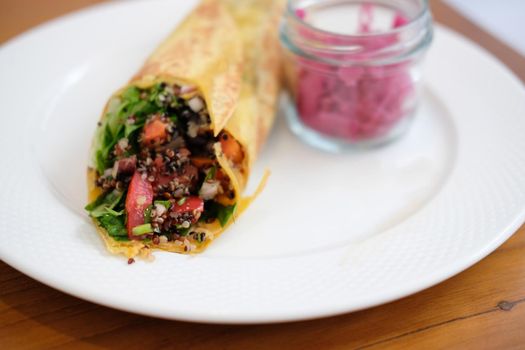vegan wrap with quinoa, black bean, mango, cashew nut, bell pepper