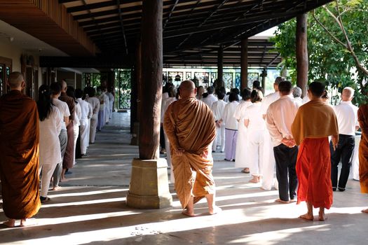 Chiang Mai, Thailand -  November 18, 2020: buddhist monk and people walking for mindfulness meditation at Khumphucome hotel in Chiang Mai, Thailand on November 18, 2020