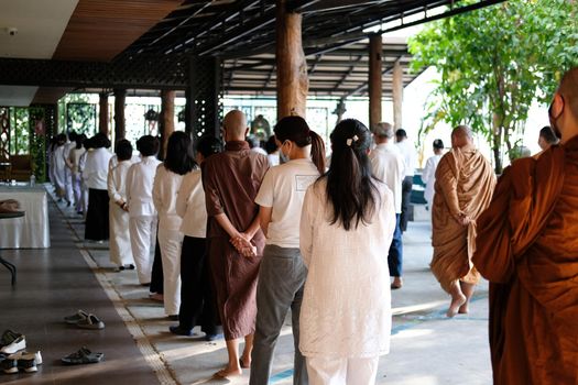 Chiang Mai, Thailand -  November 18, 2020: buddhist monk and people walking for mindfulness meditation at Khumphucome hotel in Chiang Mai, Thailand on November 18, 2020