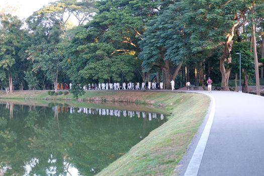 Chiang Mai, Thailand -  November 19, 2020: buddhist monk and people walking for mindfulness meditation at Chiang Mai university in Chiang Mai, Thailand on November 19, 2020