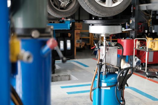 motor oil container for filling old engine oil from car in garage