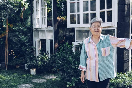 elder woman resting in garden. elderly female relaxing outdoors. senior leisure lifestyle