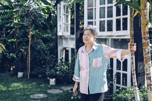 elder woman resting in garden. elderly female relaxing outdoors. senior leisure lifestyle