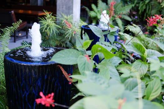 fountain on blue water jar decorating in garden