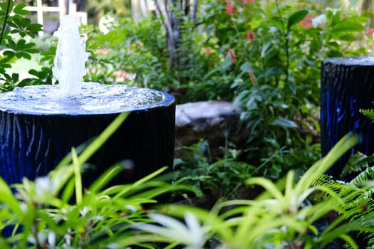 fountain on blue water jar decorating in garden