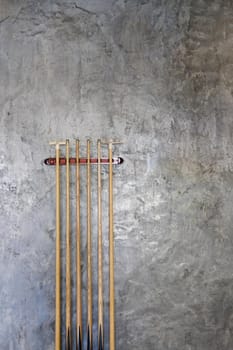 billiard cue sticks hang on wall