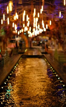 decorative light and fountain on pond abstract background