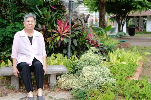 asian old elderly elder woman resting relaxing in garden. senior leisure lifestyle