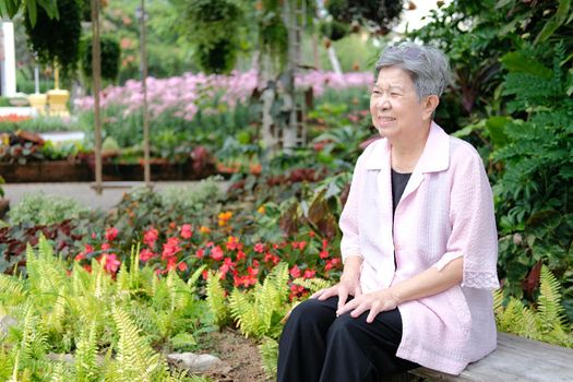 asian old elderly elder woman resting relaxing in garden. senior leisure lifestyle