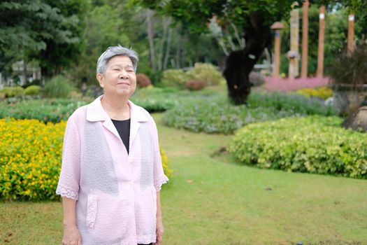 asian old elderly elder woman resting relaxing in garden. senior leisure lifestyle