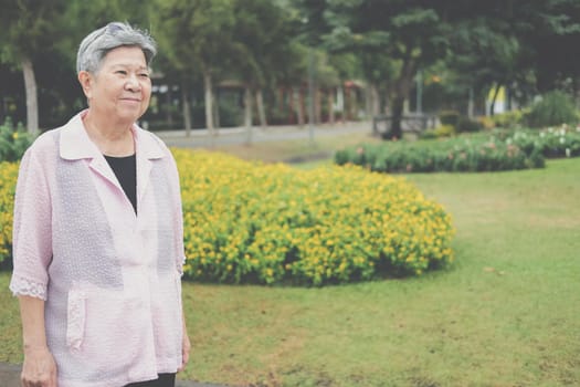 asian old elderly elder woman resting relaxing in garden. senior leisure lifestyle