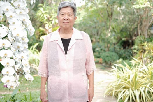 asian old elderly elder woman resting relaxing in garden. senior leisure lifestyle