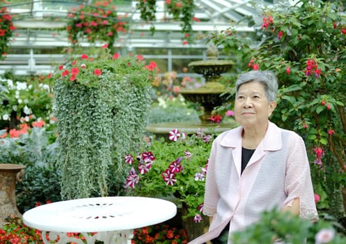 asian old elderly elder woman resting relaxing in garden. senior leisure lifestyle