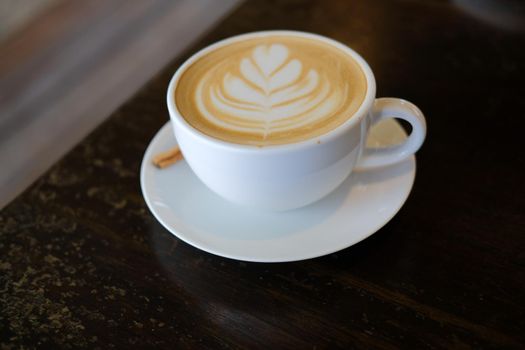 hot cappuccino mocha coffee with latte art and cinnamon.