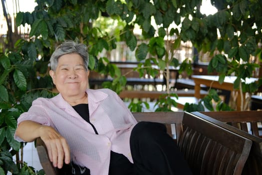 asian old elderly elder woman resting relaxing in garden. senior leisure lifestyle