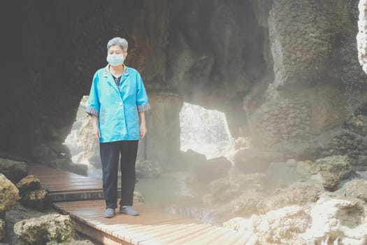 asian old elderly elder woman wearing facial mask resting relaxing in garden. senior leisure lifestyle